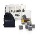 Whisky stones with a glass of whisky and packaging on a white background