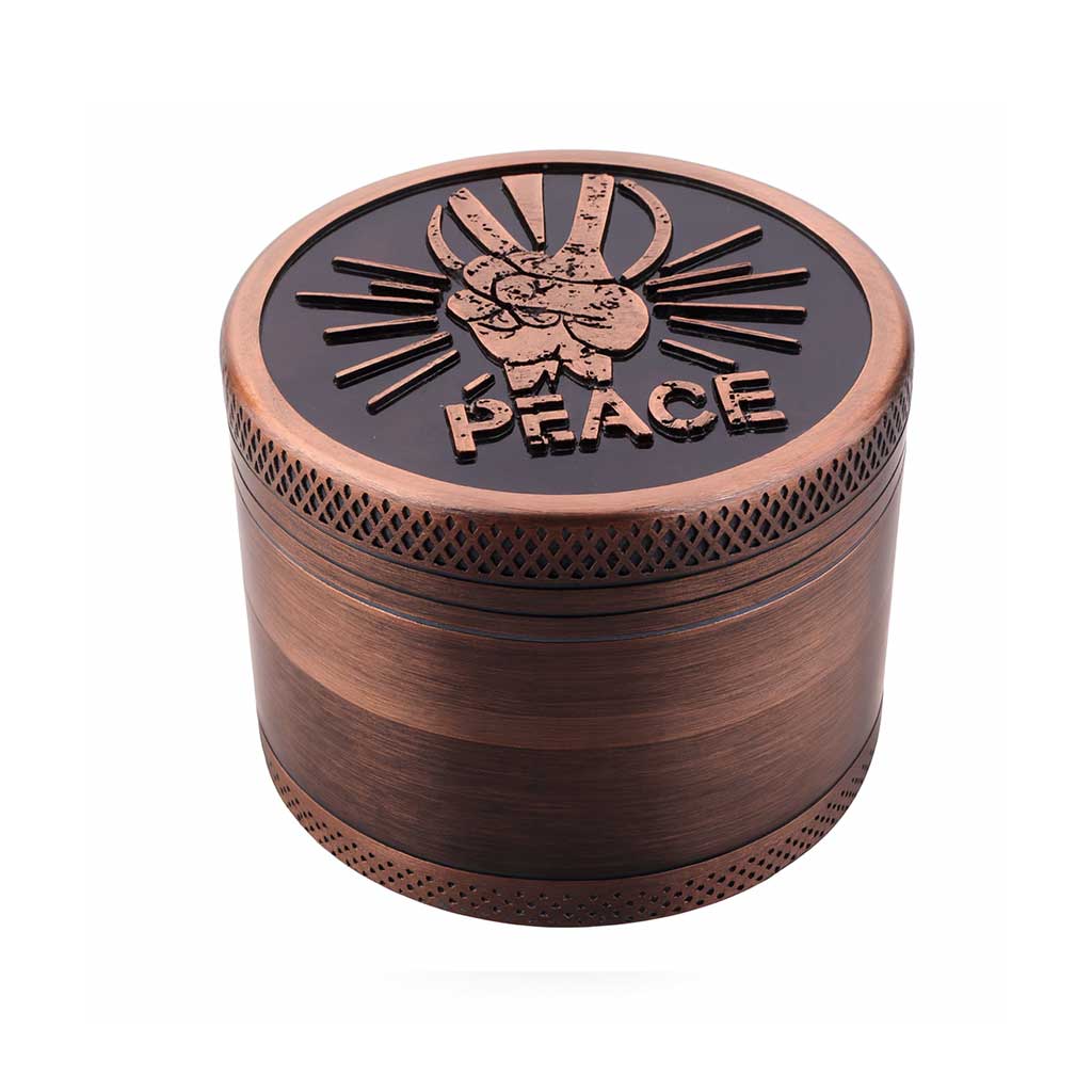 Bronze-colored grinder with 'PEACE' design on a white background