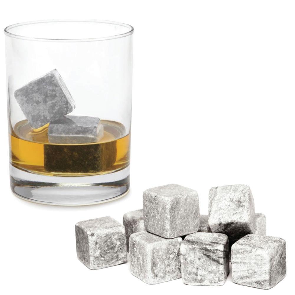 Glass of whiskey with whiskey stones and additional stones on a white background